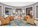 Elegant lobby with patterned rug, leather chairs, artwork, and decorative fall accents at 109 Falling Acorn Ave, Groveland, FL 34736