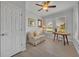 Office featuring a ceiling fan, wood floors, a sofa, a desk, and natural light at 109 Falling Acorn Ave, Groveland, FL 34736