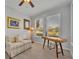 Office featuring a ceiling fan, wood floors, a sofa, a desk, and natural light at 109 Falling Acorn Ave, Groveland, FL 34736