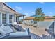 The outdoor patio features a comfortable seating area, a dining table, and a brick-paved deck at 109 Falling Acorn Ave, Groveland, FL 34736