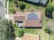Aerial view of a roof with solar panels above a back patio with seating at 109 Falling Acorn Ave, Groveland, FL 34736