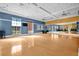 Bright studio with hardwood floors, mirrored wall, and large windows, ideal for fitness classes at 109 Falling Acorn Ave, Groveland, FL 34736