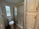 Bathroom with a toilet, shower with glass door and cabinets at 10905 Se 127Th Ln, Belleview, FL 34420