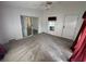 Bedroom with a ceiling fan, natural light, and slider door access at 10905 Se 127Th Ln, Belleview, FL 34420