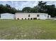 Single Gathering home featuring a detached garage and manicured landscaping at 10905 Se 127Th Ln, Belleview, FL 34420