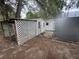 View of the sheds with white lattice and a covered area, nestled in a yard at 10905 Se 127Th Ln, Belleview, FL 34420