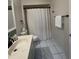 Bathroom with decorative tiles, granite countertop, and bathtub shower at 1105 Hazelnut Dr, Leesburg, FL 34748