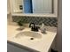 Close up of a sink with decorative accents and white marble style countertops at 1105 Hazelnut Dr, Leesburg, FL 34748