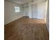Bedroom featuring laminate floors, a window, and a closet, offering a comfortable and functional space at 1105 Hazelnut Dr, Leesburg, FL 34748