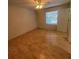 Bright bedroom with window, fan, and neutral walls at 1105 Hazelnut Dr, Leesburg, FL 34748