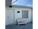 Exterior view of the property with an exterior chair and the building number at 1105 Hazelnut Dr, Leesburg, FL 34748