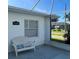 Inviting front porch featuring a comfortable chair and a view of the street at 1105 Hazelnut Dr, Leesburg, FL 34748