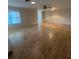 Bright living room with ceiling fan and updated flooring, a great space for entertaining at 1105 Hazelnut Dr, Leesburg, FL 34748