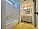 Bathroom featuring a bathtub, sink with vanity, and a tall storage cabinet for ample storage at 112 Caladium St, Leesburg, FL 34748