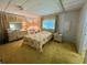 Serene bedroom featuring classic furnishings and large window at 112 Caladium St, Leesburg, FL 34748