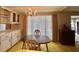 Dining area with chandelier, built in cabinets and a large window with curtains at 112 Caladium St, Leesburg, FL 34748