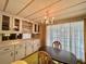 Dining area with chandelier, built in cabinets and a large window with curtains at 112 Caladium St, Leesburg, FL 34748