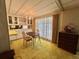 Cozy dining room featuring vintage chandelier, carpet and built in china cabinet at 112 Caladium St, Leesburg, FL 34748