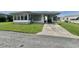 Charming single-story home featuring a covered carport and well-maintained lawn at 112 Caladium St, Leesburg, FL 34748