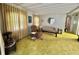 Comfortable living room featuring a plush armchair, neutral sofa, and bright window lighting at 112 Caladium St, Leesburg, FL 34748