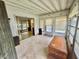 Enclosed sunroom with walls of windows and a sliding door offering a bright and airy space at 112 Caladium St, Leesburg, FL 34748