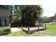 Backyard featuring a wooden deck with access to the lawn, lush landscaping, and waterfront views at 11401 Cypress Dr, Clermont, FL 34711