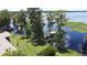 Expansive backyard featuring mature trees, lush lawn, and a private dock for serene waterfront enjoyment at 11401 Cypress Dr, Clermont, FL 34711