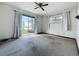 View of the bedroom with a sliding glass door and neutral carpet at 11401 Cypress Dr, Clermont, FL 34711