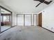 Bedroom with multiple closets and sliding door that leads to the lanai at 11401 Cypress Dr, Clermont, FL 34711