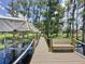 Waterfront dock features seating and access to boat lift, perfect for enjoying the serene lake views at 11401 Cypress Dr, Clermont, FL 34711