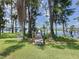 A wooden walkway stretches to a dock on a lake, framed by trees and foliage at 11401 Cypress Dr, Clermont, FL 34711