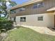 Exterior side view of the home, highlighting the brick-paved patio and well-maintained lawn at 11401 Cypress Dr, Clermont, FL 34711