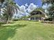 Wide shot of the home's exterior from the expansive backyard, showcasing its upper-level sunroom at 11401 Cypress Dr, Clermont, FL 34711