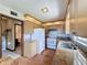 A charming kitchen is equipped with essential appliances and a view leading to the bathroom at 11401 Cypress Dr, Clermont, FL 34711