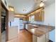 Traditional kitchen featuring granite countertops, stainless steel sink, and wood flooring at 11401 Cypress Dr, Clermont, FL 34711