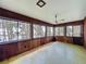Enclosed lanai featuring wood paneling and multiple windows with outdoor view at 11401 Cypress Dr, Clermont, FL 34711