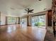 Spacious room with stone fireplace, hardwood floors, and views of lake at 11401 Cypress Dr, Clermont, FL 34711