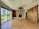 Large living room with wood floors, stone fireplace, and sliding glass doors at 11401 Cypress Dr, Clermont, FL 34711