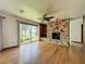 Spacious living room featuring a stone fireplace and scenic lake views at 11401 Cypress Dr, Clermont, FL 34711