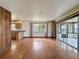 Bright living room with hardwood floors and access to an enclosed sunroom at 11401 Cypress Dr, Clermont, FL 34711