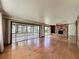 Living room with hardwood floors, stone fireplace, and view to sunroom and lake at 11401 Cypress Dr, Clermont, FL 34711