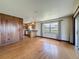 Bright room featuring hardwood floors with view to kitchen and window with view at 11401 Cypress Dr, Clermont, FL 34711