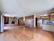 Open-concept living space with fireplace, hardwood floors, and kitchen access at 11401 Cypress Dr, Clermont, FL 34711
