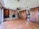 Open living area featuring wood floors, stone fireplace, and natural light at 11401 Cypress Dr, Clermont, FL 34711