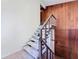 View of the staircase with wood paneling and tiled floors at 11401 Cypress Dr, Clermont, FL 34711