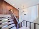 View of the staircase with wood paneling and a chandelier at 11401 Cypress Dr, Clermont, FL 34711