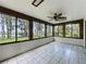 Sun room with tile floor and multiple windows offering panoramic views of the lake at 11401 Cypress Dr, Clermont, FL 34711