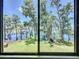 Picturesque waterfront view framed by trees at 11401 Cypress Dr, Clermont, FL 34711
