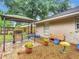 Inviting backyard features a gazebo with grill, wooden bench, potted plants and a bird bath at 12181 Se 87Th Ct, Belleview, FL 34420