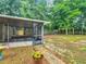 Expansive backyard features a screened in porch with a playground set beyond at 12181 Se 87Th Ct, Belleview, FL 34420